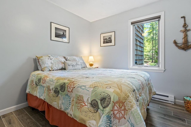131 Temple Ave Unit 26, Old Orchard Beach, ME 04064 - bedroom featuring baseboard heating, baseboards, and wood finish floors