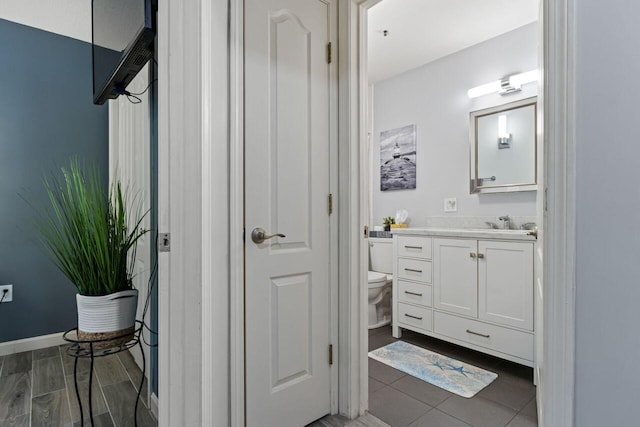 131 Temple Ave Unit 26, Old Orchard Beach, ME 04064 - bathroom featuring vanity, toilet, and baseboards