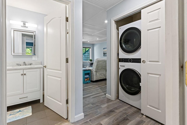 131 Temple Ave Unit 26, Old Orchard Beach, ME 04064 - laundry room with stacked washing machine and dryer, light wood-style flooring, and baseboards