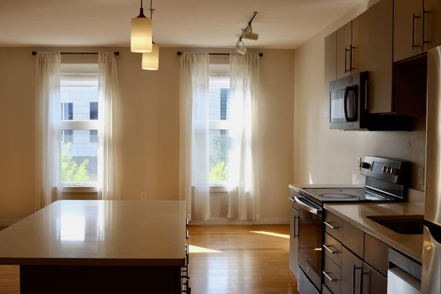65 Munjoy St Unit 4, Portland, ME 04101 - kitchen featuring stainless steel electric range oven, dishwasher, plenty of natural light, and light wood-style flooring