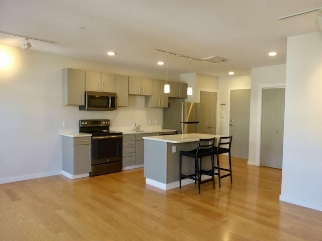65 Munjoy St Unit 4, Portland, ME 04101 - kitchen with appliances with stainless steel finishes, track lighting, gray cabinets, light countertops, and recessed lighting