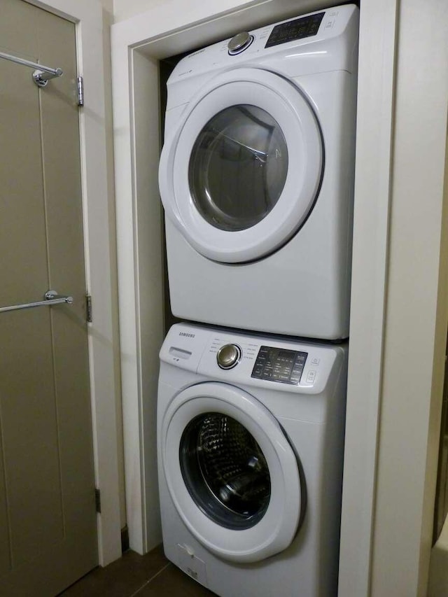 65 Munjoy St Unit 4, Portland, ME 04101 - washroom featuring stacked washing machine and dryer and dark tile patterned floors
