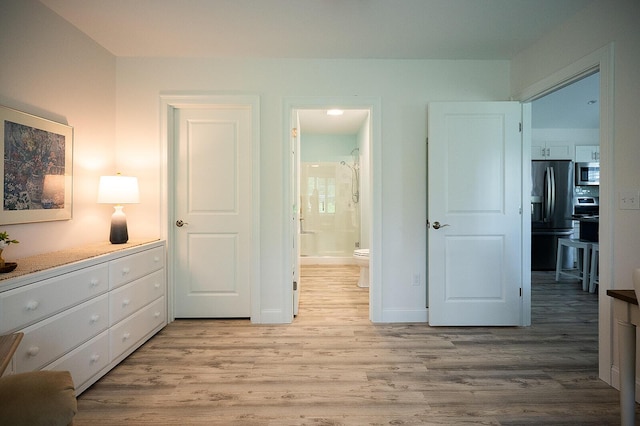 11 Unity Ln Unit 11, Windham, ME 04062 - bedroom featuring refrigerator with ice dispenser, light wood-style floors, and ensuite bath