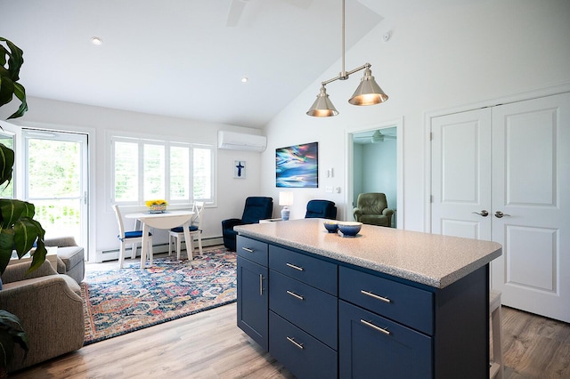11 Unity Ln Unit 11, Windham, ME 04062 - kitchen featuring open floor plan, a wall unit AC, a baseboard radiator, blue cabinets, and high vaulted ceiling