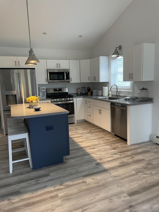 11 Unity Ln Unit 11, Windham, ME 04062 - kitchen with appliances with stainless steel finishes, a sink, lofted ceiling, a center island, and white cabinets