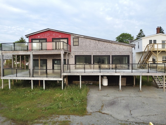 32 Water St, Lubec, ME 04652 - back of property with stairs, a balcony, and brick siding