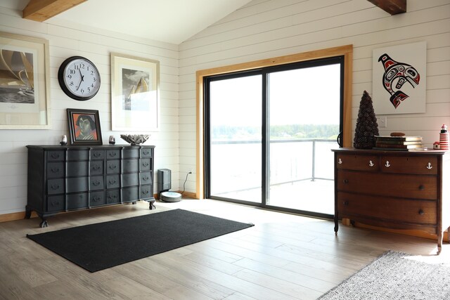 32 Water St, Lubec, ME 04652 - living area featuring vaulted ceiling, wooden walls, and wood finished floors