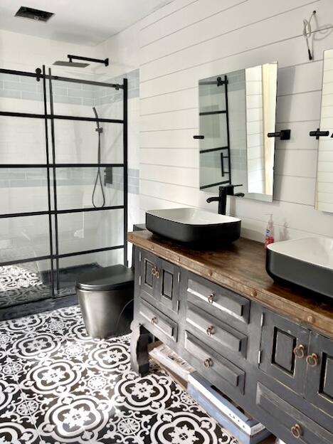 32 Water St, Lubec, ME 04652 - full bath featuring double vanity, a tile shower, and wood walls