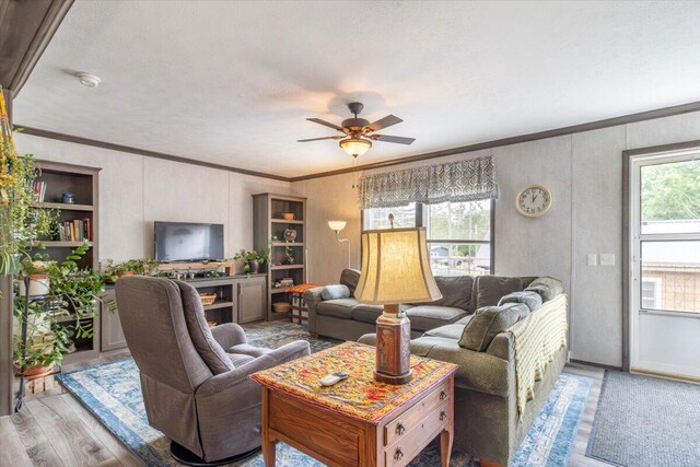 833 Sedgwick Ridge Rd, Sedgwick, ME 04676 - living room with crown molding, wood finished floors, and ceiling fan