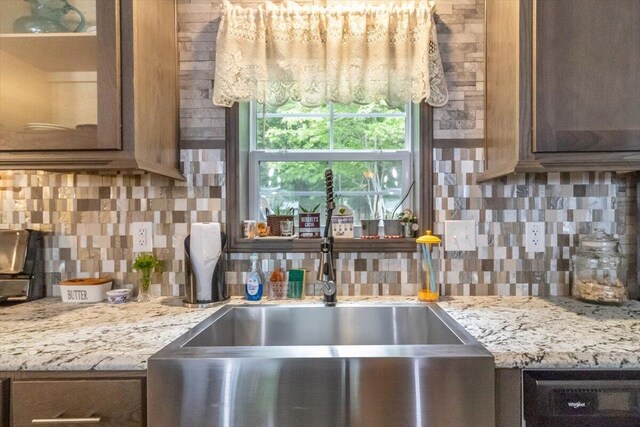 833 Sedgwick Ridge Rd, Sedgwick, ME 04676 - kitchen with backsplash, glass insert cabinets, and light stone counters