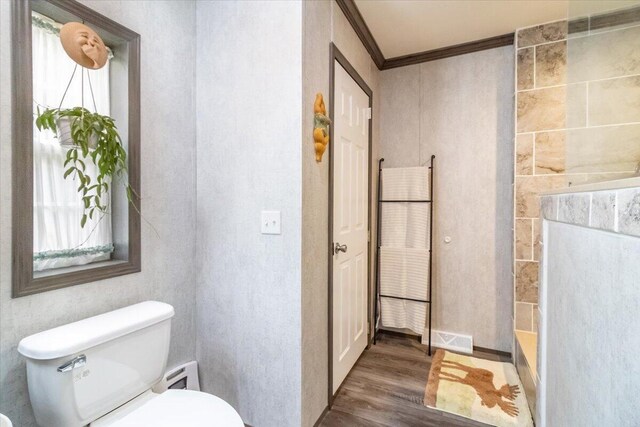 833 Sedgwick Ridge Rd, Sedgwick, ME 04676 - full bathroom with wood finished floors, crown molding, a tub to relax in, and a fireplace