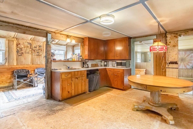 833 Sedgwick Ridge Rd, Sedgwick, ME 04676 - kitchen with brown cabinetry, light countertops, wood walls, and stainless steel microwave