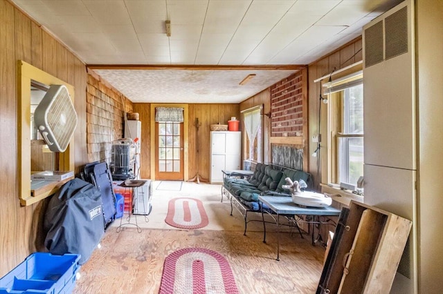 833 Sedgwick Ridge Rd, Sedgwick, ME 04676 - living room featuring wood walls, a heating unit, and wood finished floors