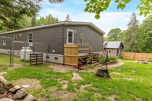 833 Sedgwick Ridge Rd, Sedgwick, ME 04676 - rear view of house with a gate, crawl space, and a wooden deck