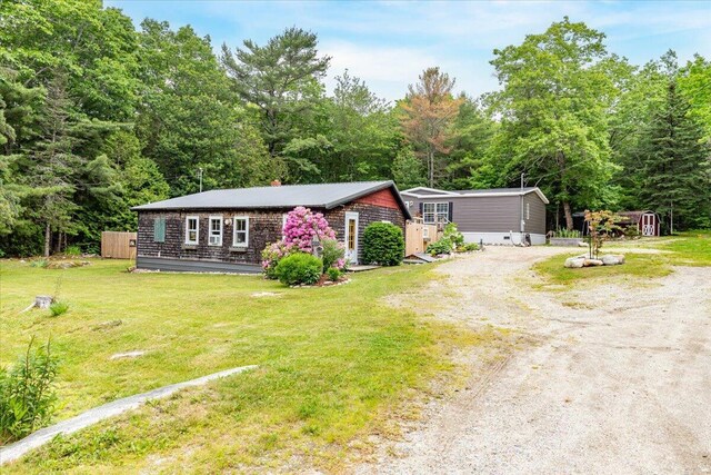 833 Sedgwick Ridge Rd, Sedgwick, ME 04676 - view of front of property with driveway, a front yard, and a chimney