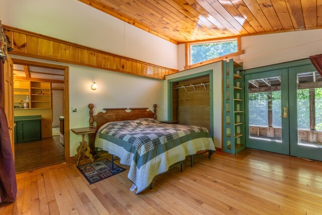 200 Flanders Pond Rd, Sullivan, ME 04664 - bedroom with french doors, multiple windows, wooden ceiling, hardwood / wood-style flooring, and access to exterior