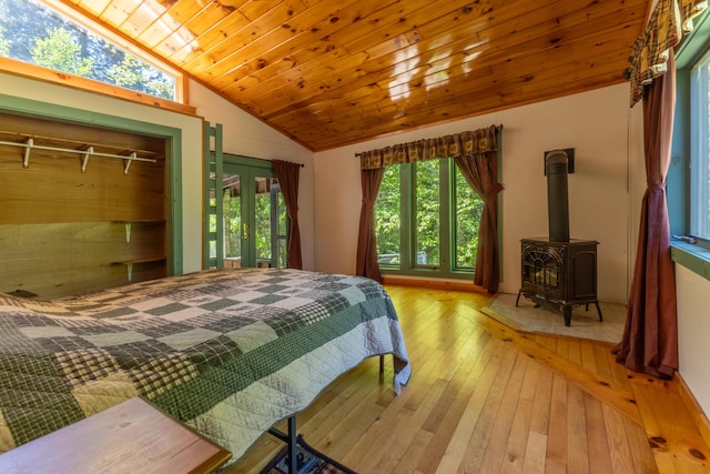 200 Flanders Pond Rd, Sullivan, ME 04664 - bedroom featuring lofted ceiling, hardwood / wood-style floors, a wood stove, and wood ceiling