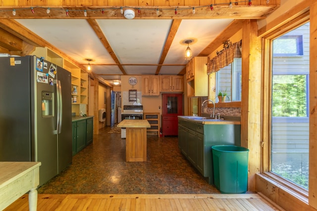 200 Flanders Pond Rd, Sullivan, ME 04664 - kitchen featuring stainless steel fridge with ice dispenser, a sink, stove, a kitchen island, and healthy amount of natural light