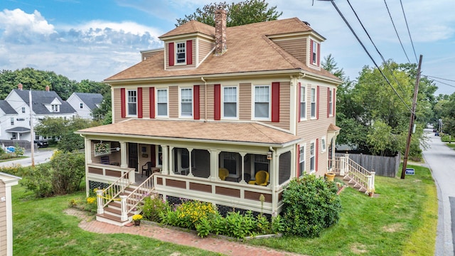 view of front of house with a chimney and a shingled roof