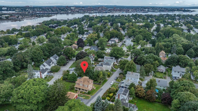 aerial view of property and surrounding area featuring a nearby body of water