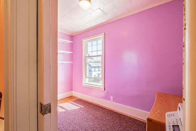 unfurnished room with baseboards
