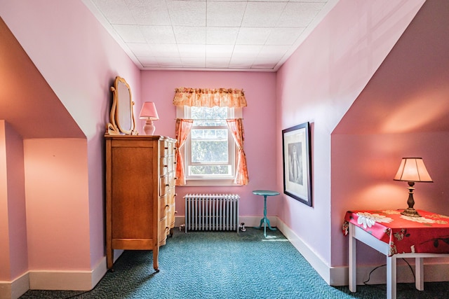 sitting room featuring radiator heating unit, carpet, and baseboards