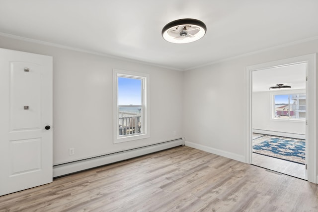 5 Kinney Ave Unit 303, Old Orchard Beach, ME 04064 - spare room featuring a baseboard radiator, crown molding, wood finished floors, baseboards, and baseboard heating