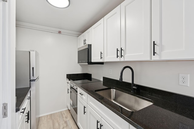 5 Kinney Ave Unit 303, Old Orchard Beach, ME 04064 - kitchen featuring appliances with stainless steel finishes, a sink, white cabinets, and dark stone counters