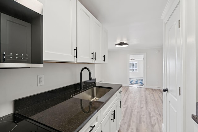 5 Kinney Ave Unit 303, Old Orchard Beach, ME 04064 - kitchen featuring a sink, dark stone counters, light wood-type flooring, and white cabinetry