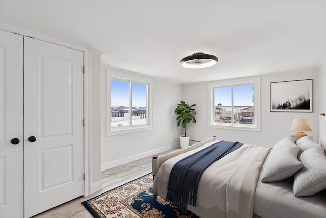 5 Kinney Ave Unit 303, Old Orchard Beach, ME 04064 - bedroom featuring light wood-style flooring, baseboards, and crown molding