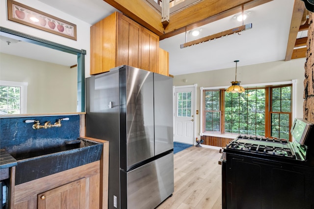 30 Otter Cove Ln, North Berwick, ME 03906 - kitchen featuring freestanding refrigerator, light wood-type flooring, black gas stove, decorative light fixtures, and baseboards