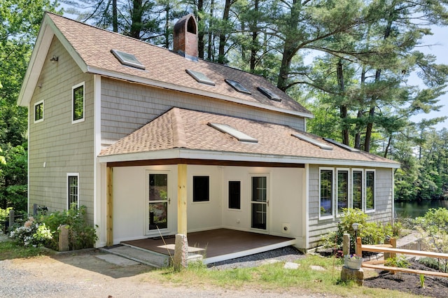 30 Otter Cove Ln, North Berwick, ME 03906 - rear view of house with roof with shingles, a chimney, and a wooden deck