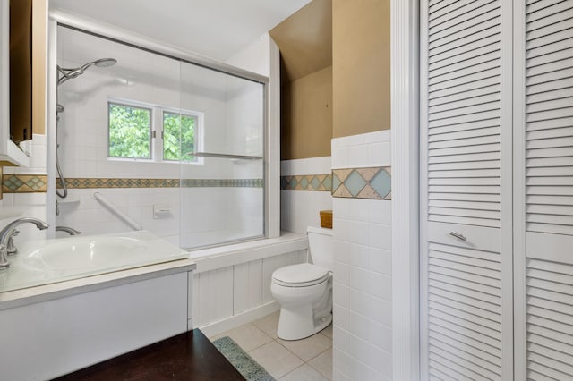 30 Otter Cove Ln, North Berwick, ME 03906 - full bath featuring a closet, tile walls, toilet, tile patterned flooring, and combined bath / shower with glass door