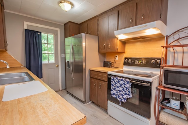 26 Knapp Ave, Milo, ME 04463 - kitchen featuring appliances with stainless steel finishes, under cabinet range hood, a sink, light countertops, and light wood-style floors