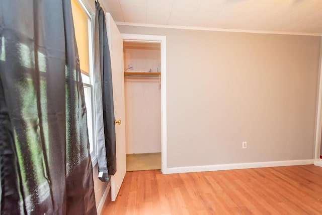 26 Knapp Ave, Milo, ME 04463 - unfurnished bedroom with crown molding, light wood finished floors, baseboards, and a closet