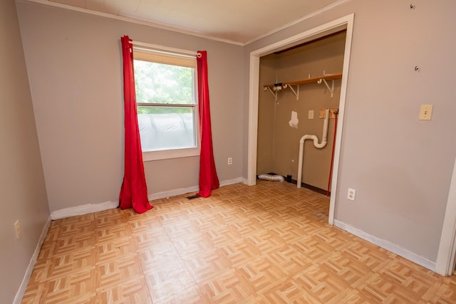 26 Knapp Ave, Milo, ME 04463 - unfurnished bedroom featuring baseboards, crown molding, and a closet