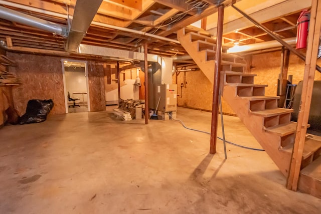 26 Knapp Ave, Milo, ME 04463 - unfinished below grade area featuring stairs and heating unit