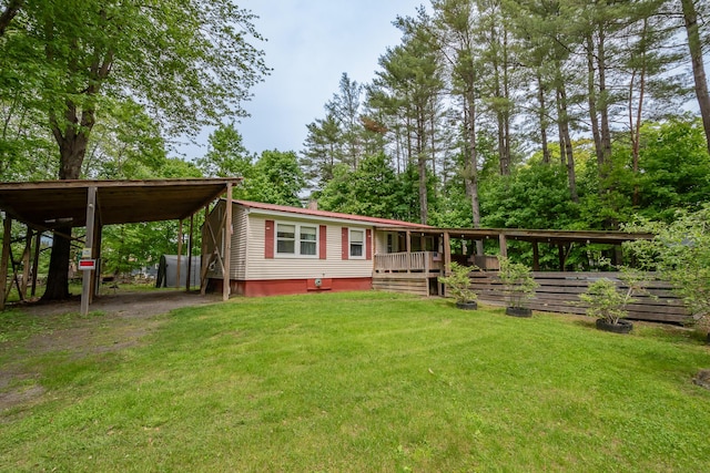 26 Knapp Ave, Milo, ME 04463 - manufactured / mobile home with a front yard, a deck, a carport, and driveway
