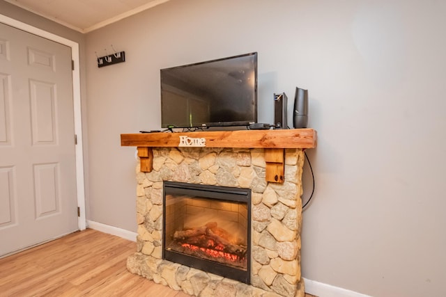 26 Knapp Ave, Milo, ME 04463 - detailed view of wood finished floors, a stone fireplace, baseboards, and ornamental molding