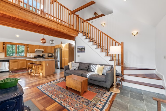 11 Pitch Pine Ln, Georgetown, ME 04548 - living room with high vaulted ceiling, stairway, and baseboards