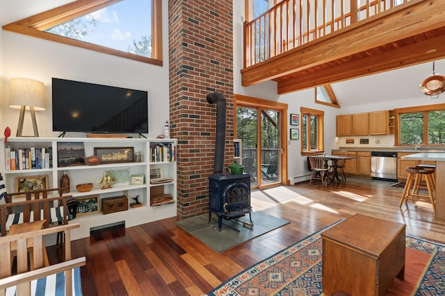 11 Pitch Pine Ln, Georgetown, ME 04548 - living room with wood-type flooring, a wood stove, beamed ceiling, high vaulted ceiling, and a baseboard heating unit