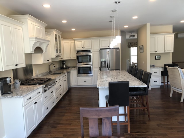 9 Atkinson Ln, Saco, ME 04072 - kitchen featuring stainless steel appliances, a sink, a kitchen bar, white cabinets, and recessed lighting