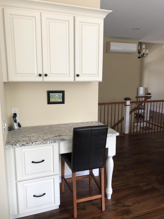 9 Atkinson Ln, Saco, ME 04072 - office space featuring an AC wall unit, built in desk, dark wood-style floors, and a chandelier