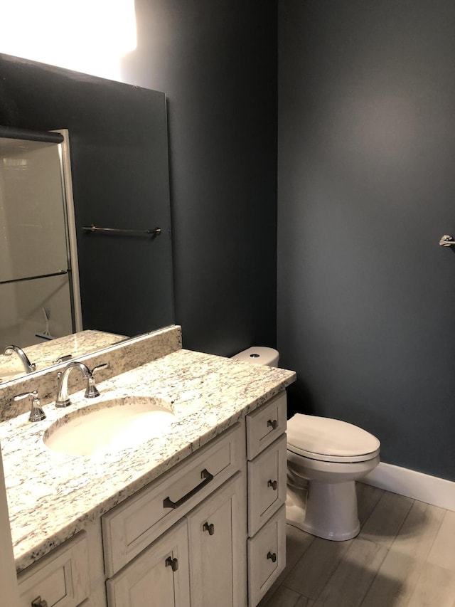 9 Atkinson Ln, Saco, ME 04072 - bathroom with toilet, vanity, and baseboards