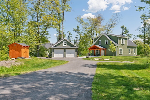 29 Bay Field Dr, Woolwich, ME 04579 - view of front of home with a front yard, a garage, and a shed