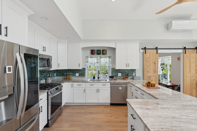 29 Bay Field Dr, Woolwich, ME 04579 - kitchen featuring appliances with stainless steel finishes, an AC wall unit, plenty of natural light, backsplash, and recessed lighting