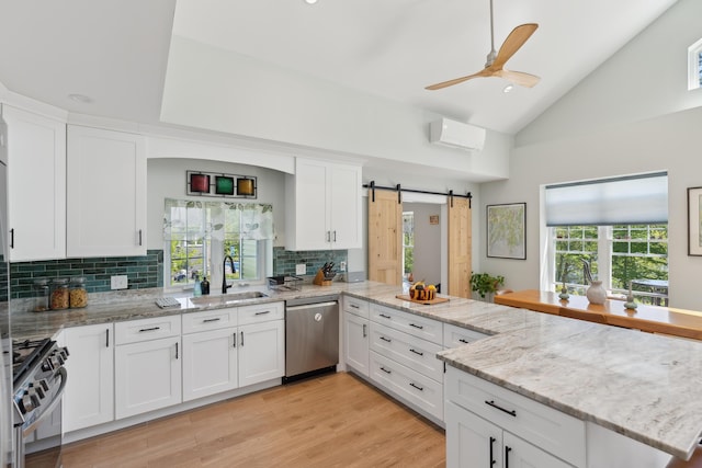 29 Bay Field Dr, Woolwich, ME 04579 - kitchen with appliances with stainless steel finishes, tasteful backsplash, white cabinetry, ceiling fan, and a peninsula