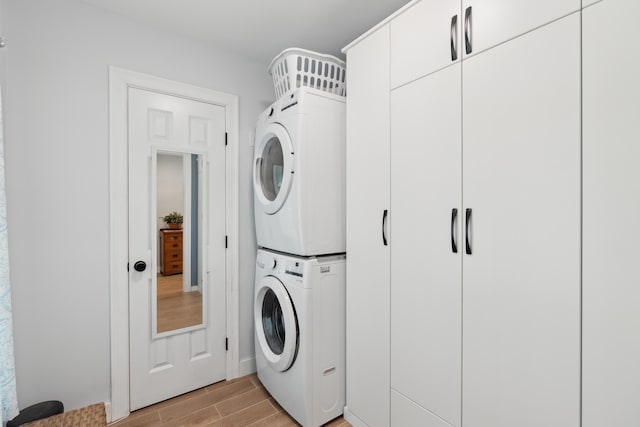 29 Bay Field Dr, Woolwich, ME 04579 - laundry area featuring stacked washing machine and dryer and wood tiled floors