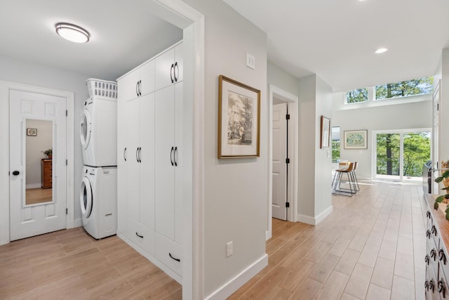 29 Bay Field Dr, Woolwich, ME 04579 - laundry room with stacked washer and clothes dryer, light wood finished floors, and recessed lighting