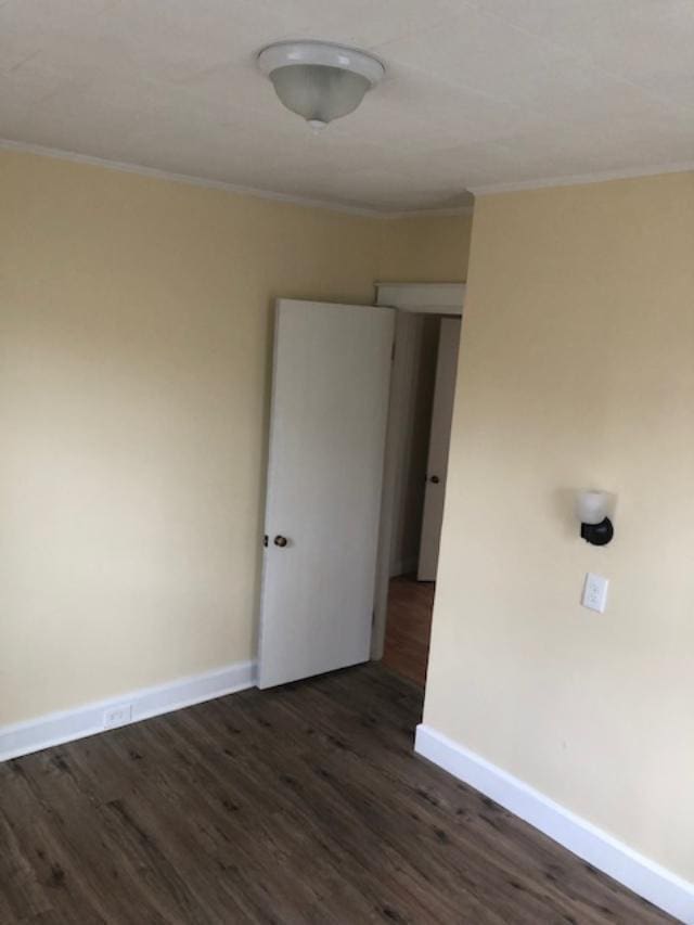 29 13th St, Bangor, ME 04401 - spare room featuring baseboards, dark wood-style flooring, and ornamental molding